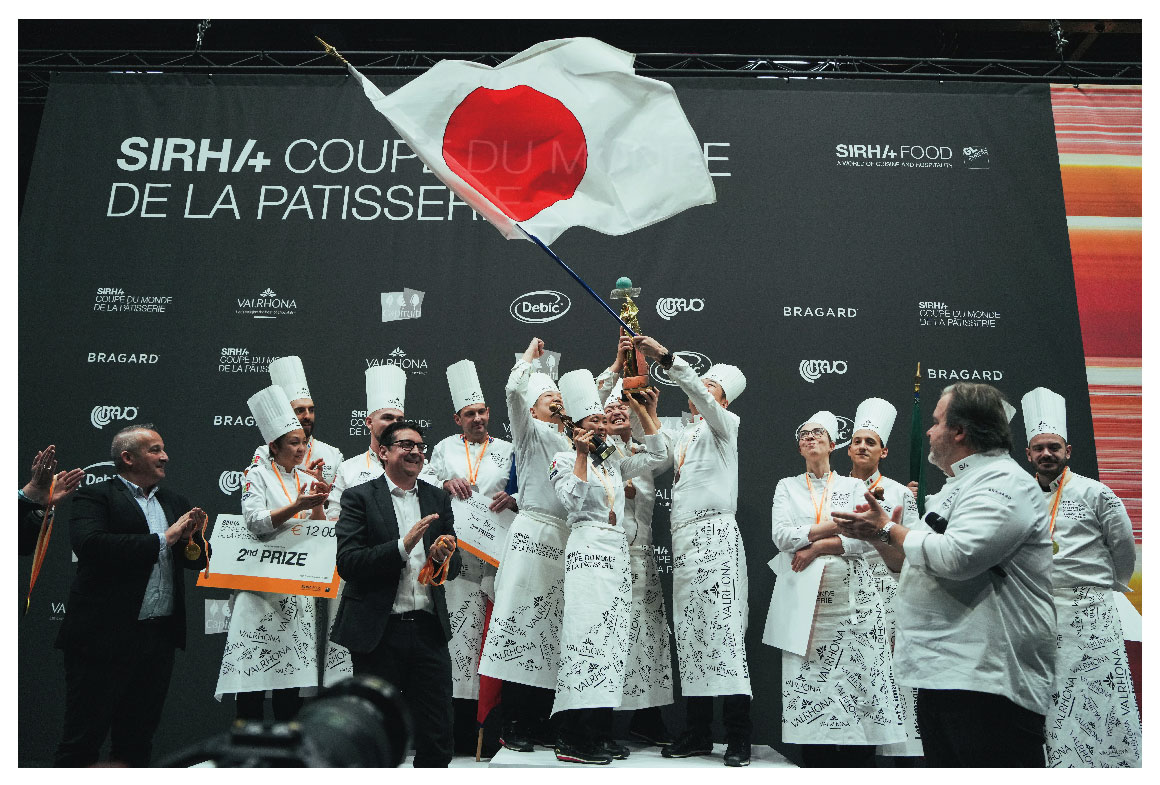 Team Japan joyfully celebrating their victory on the podium at the 2023 competition